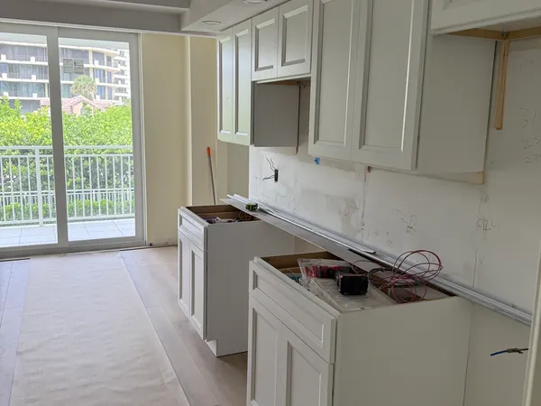 Brigadoon Renovation — Kitchen cabinetry going in beside the balcony slider