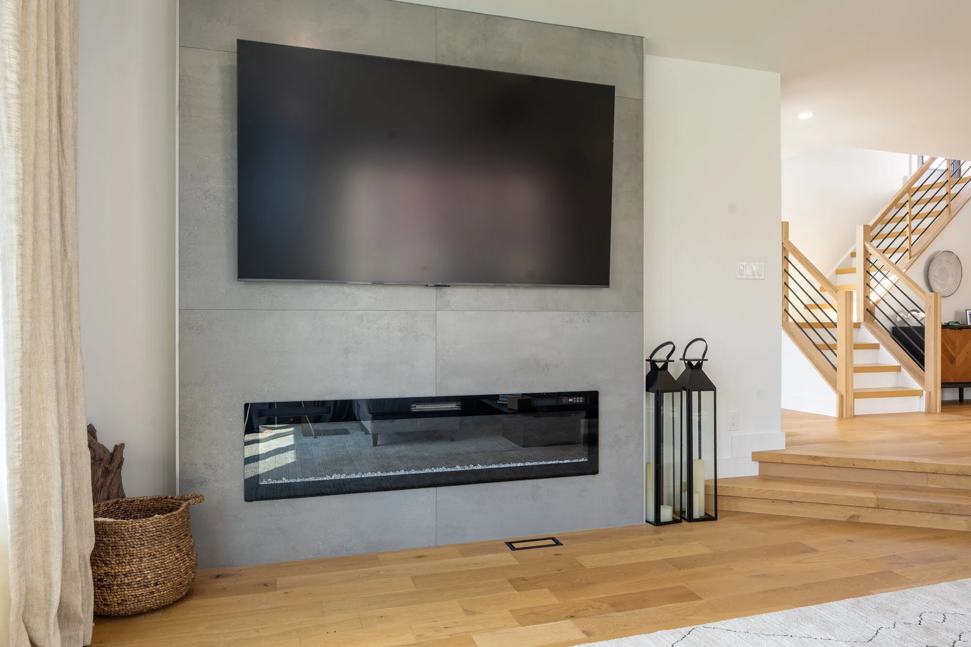 Great room with a linear fireplace and white oak floors in a renovated Margate, NJ home