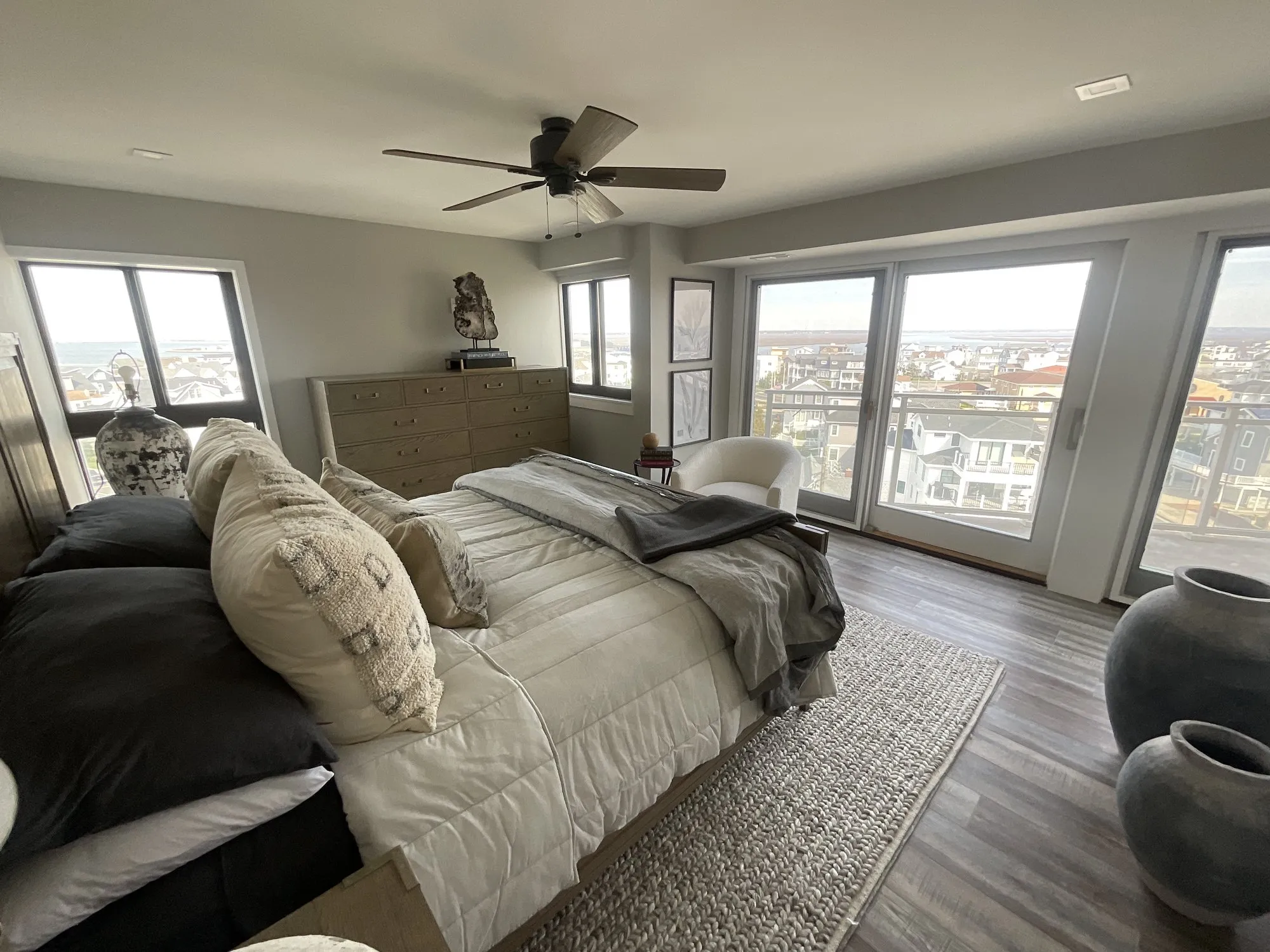 Primary bedroom with sliding glass doors and wide bay views in Longport, NJ