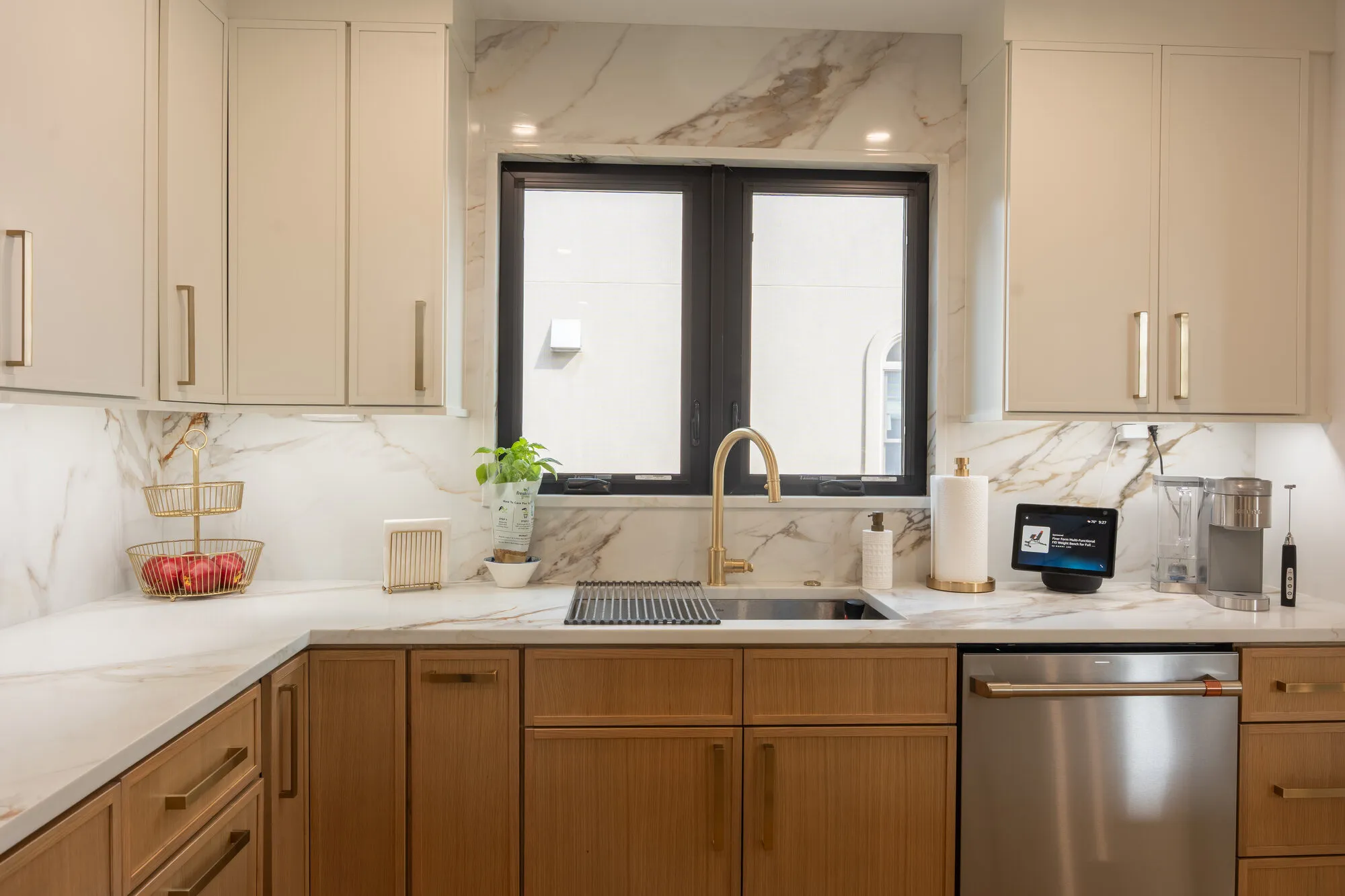 Kitchen with marble slab backsplash, brass faucet, and rift oak cabinets from a Seaboard West Palm Beach renovation